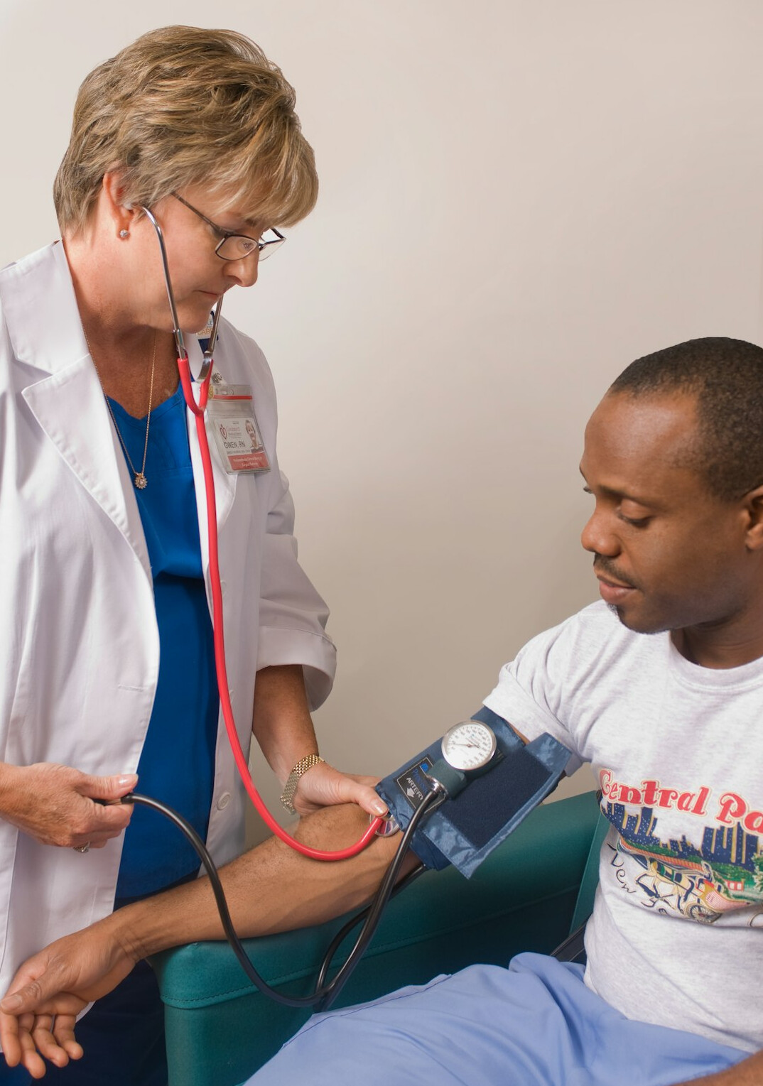 Health professional measuring blood pressure of an employee