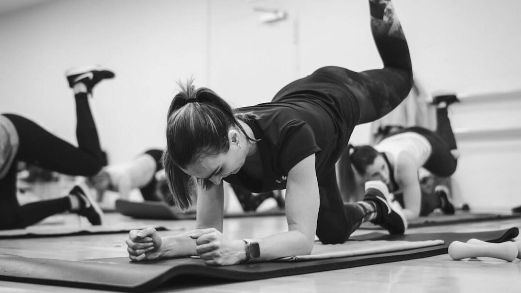Group fitness class in a bright office wellness room