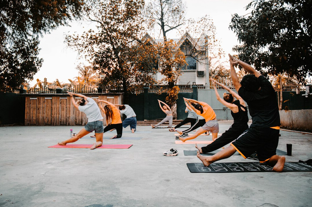 Group yoga class for employees in an office studio